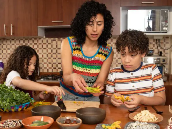 Hispanic woman cooks dinner with her family