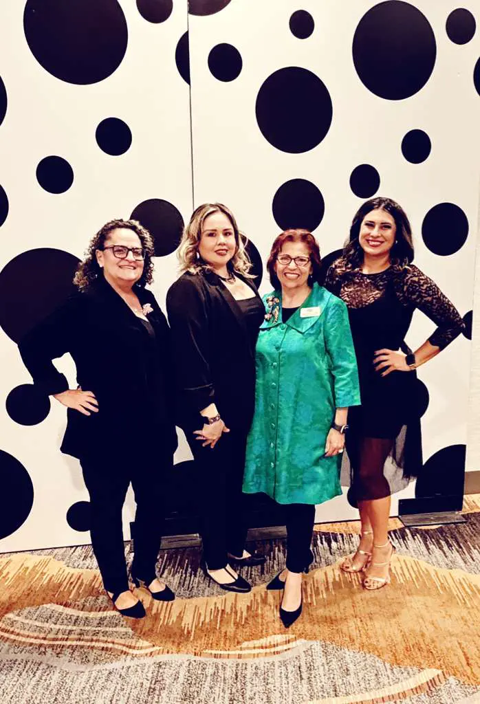 Group of four women from the Cancer Resource Center of the Desert standing together at an event. 