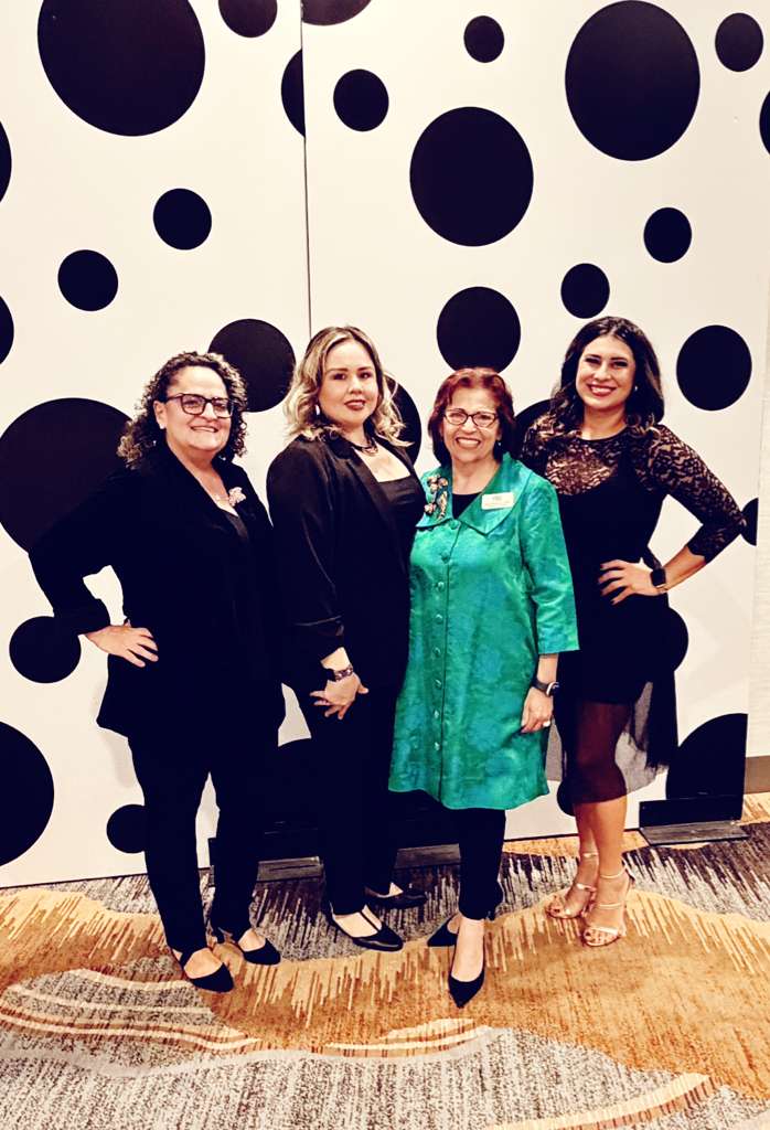 Group of four women from the Cancer Resource Center of the Desert standing together at an event. 